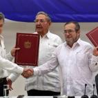 El delegado de las FARC en Cuba, Rodrigo Londoño Echeverri, alias 'Timochenko' (d) y el presidente de Colombia, Juan Manuel Santos (i) junto a el presidente de Cuba, Raúl Castro (c) sostienen en sus manos el acuerdo de paz entre el Gobierno co...