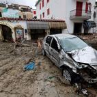 Mud covers streets and cars after heavy rainfall triggered landslides that collapsed buildings and left as many as 12 people missing, in Casamicciola, on the southern Italian island of Ischia, Italy, Saturday, Nov. 26, 2022. Firefighters are wor...