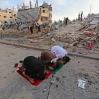 Los palestinos realizan la oraci&oacute;n de Eid al-Fitr cerca de las ruinas de los edificios destruidos por los ataques a&eacute;reos israel&iacute;es en Gaza