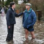 El líder del Partido Laborista, Ed Miliband, habla con un vecino en Wraysbury. Las lluvias han afectado también al servicio ferroviario que enlaza el suroeste con el resto del país, lo que ha forzado a ampliar las conexiones aéreas.