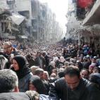Colas kilométricas de refugiados sirios se agolpan para conseguir alimentos en calles destrozadas por la guerra en Yarmuk, cerca de Damasco. La imagen es parte de una galería tomada el pasado 31 de enero por Agencia de Naciones Unidas para los...