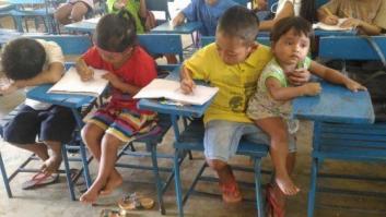 La imagen de un niño filipino atendiendo en clase con su hermana en brazos que ha dado la vuelta al mundo
