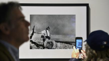 A visitor takes a snapshot of Robert Capa's “The falling soldier, Spain, 1936” during the 'Life. I grandi fotografi" (Life. The great photographers) exhibition at the auditorium on April 30, 2013 in Rome. The exhibition showing some 150 pict...