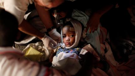 An injured child receives medical treatment after a 7.0 magnitude earthquake in Port-au-Prince, Haiti, January 13, 2010. Picture taken January 13, 2010. REUTERS/Eduardo Munoz/File Photo  SEARCH "POY DECADE" FOR THIS STORY. SEARCH "REUTERS POY" F...