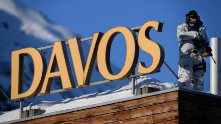 A policeman wearing camouflage clothing stands on the rooftop of a hotel near the Congress Centre during the World Economic Forum (WEF) annual meeting in Davos, on January 20, 2020. (Photo by Fabrice COFFRINI / AFP) (Photo by FABRICE COFFRINI/AF...
