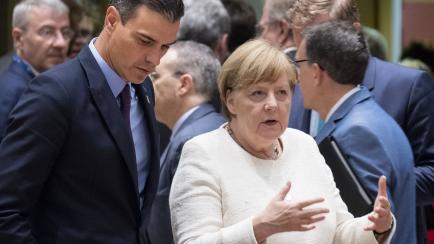 BRUSSELS, BELGIUM - JUNE 20, 2019 : Spanish President of the government Pedro Sanchez Perez-Castejon (L) is talking with the German Chancellor Angela Merkel (R) at the start of an European Union Prime Minister and chief of state Summit on June 2...