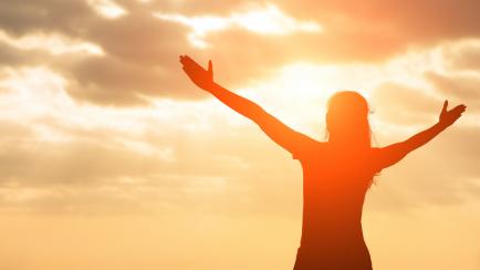 silhouette of woman pray with sunlight