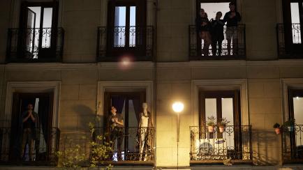 MADRID, SPAIN - MARCH 14: People applaud Spanish health workers during a COVID-19 emergency, on March 14, 2020 in Madrid, Spain. The Spanish Government has taken the unprecedented measure of a nationwide lockdown by closing all businesses except...