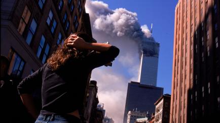 Shocked crowds of downtown Manhattanites observe the burning World Trade Center towers in New York City early September 11, 2001. Three hijacked planes crashed into major U.S. landmarks on the same day, destroying both of New York's twin towers ...