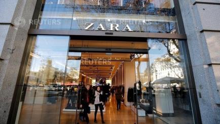 FILE PHOTO: People leave a Zara store, an Inditex brand, in central Barcelona