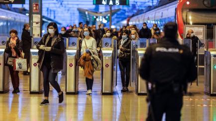 VALENCIA, SPAIN - APRIL 14: A local police officer prepares to deliver masks to commuters at Norte Station on the first working day in Valencia after Easter holidays during the coronavirus (COVID-19) crisis on April 14, 2020 in Madrid, Spain. Th...