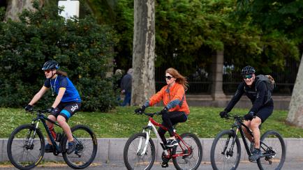 MADRID, SPAIN - MAY 02: People are seen cycling through Paseo del Prado on the first day since Spain eased the Covid-19 lockdown measures to allow exercise on May 2, 2020 in Madrid, Spain. Spain continues to ease the Covid-19 lockdown measures t...