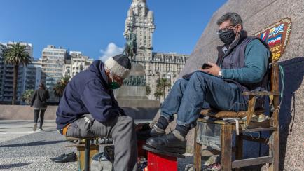 MONTEVIDEO, URUGUAY - MAY 07: A customer gets his shoes polished at Plaza Independencia on May 07, 2020 in Montevideo, Uruguay. President Lacalle Pou called for a reopening of certain industries and encouraged people to take preventive measures ...