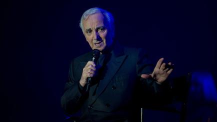 In this photo taken on November 23, 2011 in Tours, French late singer Charles Aznavour performs on stage. - The legendary French singer Charles Aznavour has died aged 94, his spokeswoman told AFP on October 1, 2018. The songwriter, who had just ...