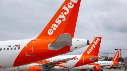 A large number of easyJet aircrafts are parked on the tarmac of the Geneve Aeroport, in Geneva, Switzerland, Monday, March 30, 2020. EasyJet, a British low-cost airline, on 30 March 2020 said it is ground its entire fleet of more than 300 planes...