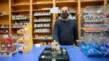 BARI, ITALY - MAY 06: Tobacco Shop's owner wears a mask on May 06, 2020 in Bari, Italy. Italy was the first country to impose a nationwide lockdown to stem the transmission of the Coronavirus (Covid-19), and its restaurants, theaters and many ot...