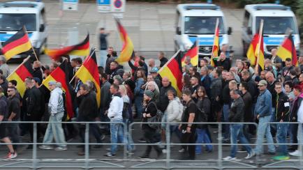 People take part in a march organised by the right-wing populist "Pro Chemnitz" movement, on September 14, 2018 in Chemnitz, the flashpoint eastern city that saw protests marred by neo-Nazi violence. (Photo by - / DPA / AFP) / Germany OUT       ...