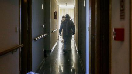 MADRID, SPAIN - MARCH 26: A soldier is seen while disinfecting the nursing home San Carlos del Bosque at the town of Villaviciosa de Odon, one of the hundreds of nursing homes the Military Emergency Unit is disinfecting in Spain on March 26, 202...