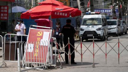A check point with the sign "Communist member pioneer station" setup near a neighborhood under lockdown in Beijing, Tuesday, June 16, 2020. China reported several dozen more coronavirus infections Tuesday as it increased testing and lockdown mea...