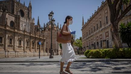 SEVILLA, SPAIN - May 29: A woman with a mask is seen at Constitución street during the fifth day of Phase 2 during the coronavirus (COVID-19) pandemic on May 29, 2020 in Sevilla, Spain. (Photo by Maria José López/Europa Press via Getty Images)