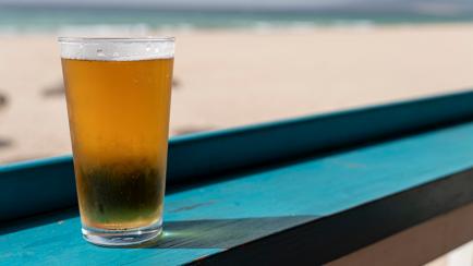 Beer glass at beach on green table