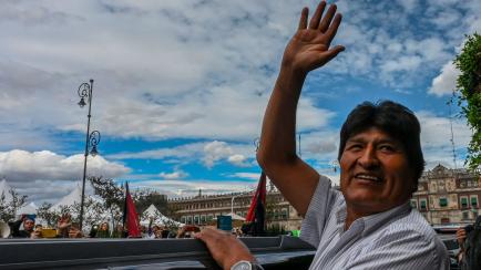 Bolivian ex-President Evo Morales waves as he leaves the Historic City Hall where he was honored as Distinguished Guest by Mexico City's Mayor Claudia Sheinbaum on November 13, 2019 in Mexico City. - Morales arrived on the eve in Mexico -which g...