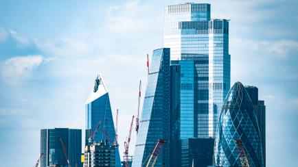 London City skyscrapers overlooking homes along River Thames
