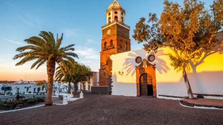 Central square with old church Nuestra Senora de Guadalupe in Teguise village on the sunset on lanzarote island