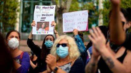Protesters hold a banner reading "More deaths than yesterday but less than tomorrow. Guilty " during a demonstration against the restrictions imposed by the regional government to fight the coronavirus spread at the Vallecas district in Madrid, ...