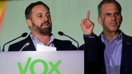 Santiago Abascal, leader of far-right Vox Party, addresses supporters outside the party headquarters after the announcement of the general election first results, in Madrid, Spain, Sunday, Nov. 10, 2019. At right is the party Secretary General J...