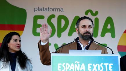Santiago Abascal, leader of the far-right party VOX, speaks next to Madrid's regional Vox leader Rocio Monasterio, during a rally in protest against the new coalition government led by Spain's Prime Minister Pedro Sanchez, at Cibeles Square in M...
