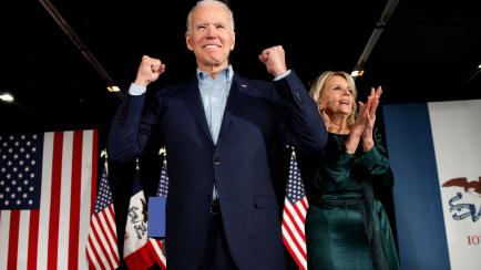 Democratic presidential candidate former Vice President Joe Biden at a caucus night campaign rally on Monday, Feb. 3, 2020, in Des Moines, Iowa with Jill Biden. (AP Photo/John Locher)