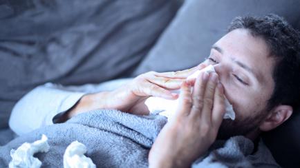 sick man , flu, cold and he has fever