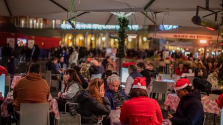 People sit in a terrace bar at Mayor square in downtown Madrid, Spain, Saturday, Dec. 12, 2020. The rate of Spain's coronavirus contagion has dropped to levels not seen since the end of August, when a resurgence began in earnest, but the country...