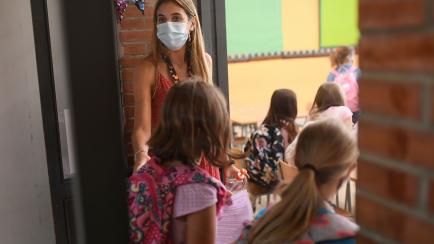 A teacher escorts students to their classroom on the first day of classes for the new academic year amid the coronavirus pandemic in Barcelona on September 14, 2020. - The first EU nation to surpass half a million coronavirus infections, Spain's...