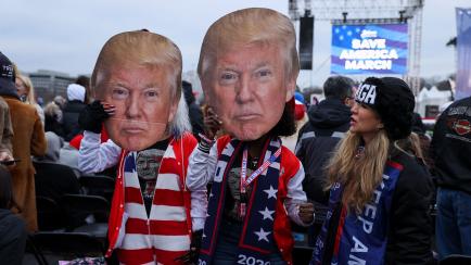 WASHINGTON, USA - JANUARY 06: Supporters hold US President Donald Trump cardboards during a "Save America Rally" near the White House in Washington, D.C., U.S., on Wednesday, Jan. 6, 2021. The House and Senate will meet in a joint session today ...