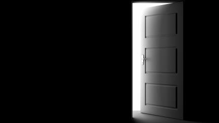 Open door in a dark room