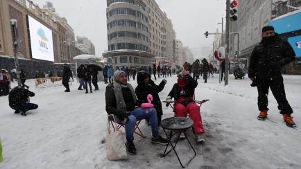 MADRID, SPAIN - JANUARY 09: People enjoy snowfall at Gran Via street after heavy snowfall hit Madrid, Spain on January 09, 2021. Spain is on red alert for a second day due to storm Filomena, which has brought unusually cold weather and heavy sno...