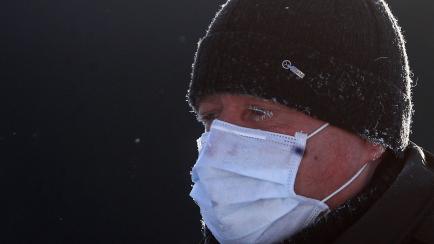 YURYEVETS, IVANOVO REGION, RUSSIA - JANUARY 13, 2021: A man in a medical mask walks in a street. The temperature in the town of Yuryevets is -30°C (-22°F). Vladimir Smirnov/TASS (Photo by Vladimir Smirnov\TASS via Getty Images)