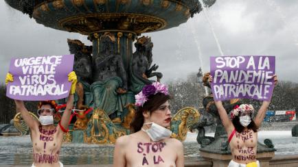 EDS NOTE NUDITY. Femen activists hold placards reading, on the left, Â«Vital emergency. Patriarchal virusÂ Â» and on the right, Â«Â Stop the patriarchal pandemicÂ Â» during a protest as part of the celebration of the International ...