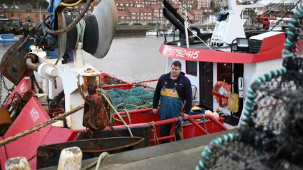 Skipper Richard Brewer stands aboard his fishing boat moored in the harbour at Whitby, northeast England, on January 4, 2021. - Britain had insisted it wanted to take back control of its waters while EU coastal states sought guarantees that thei...