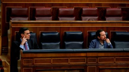 Spanish Prime Minister Pedro Sanchez (L) and Spain's Deputy Prime Minister for Social Rights and Sustainable Development Pablo Iglesias (R) attend a session at the Lower House of Parliament in Madrid, on April 29, 2020, a day after the governmen...