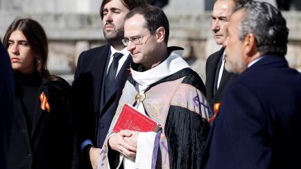 Santiago Cantera, prior of the Basilica, and relatives of late Spanish dictator Francisco Franco gather around the funeral car after the exhumation at The Valle de los Caidos (The Valley of the Fallen) in San Lorenzo de El Escorial, Spain, Octob...