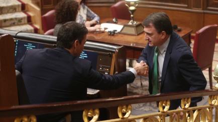 MADRID, SPAIN - JANUARY 07: The spokesman of PNV at the Parliament, Aitor Esteban (R), greets the acting president of the Government, Pedro Sanchez (L), during the second vote of the investiture of the socialist candidate for the presidency of t...