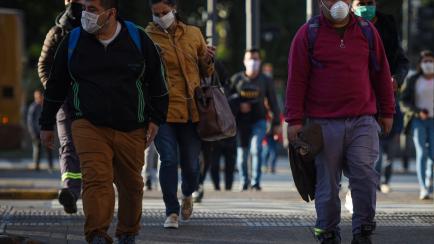 BUENOS AIRES, ARGENTINA - APRIL 14: Pedestrians wearing face masks cross the Brazil street in Constitution neighborhood on April 14, 2020 in Buenos Aires, Argentina. Since tomorrow, it will be obligatory to wear face masks in the streets and sto...