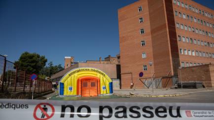 LLEIDA, SPAIN - JULY 06: Two people pass by a campaign hospital prepared to care for coronavirus patients next to the Arnau University Hospital at Lleida, capital of the Segrià region, on July 6, 2020 in Lleida, Spain. The president of the Gene...