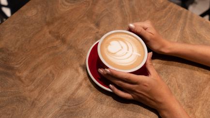 coffee latte art in hand
