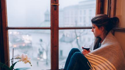 Thoughtful woman at home - copyspace