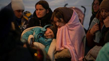 Un grupo de refugiados ucranianos descansa en una tienda de campaña tras entrar este domingo en Medyka, Polonia, en la frontera con su país. 