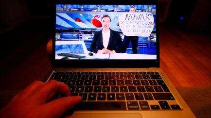 The evening news broadcast on the main Russian news channel, Channel 1 is seen on a laptop as it is interrupted by a woman protesting the war in Ukraine in this illustration photo on 15 March, 2022 in Warsaw, Poland. Marina Ovsyannikova, an empl...